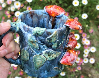 Hand made mushroom mug with blue drippy glaze and red protruding toadstools, toadstool mug, mushroom mug, blue toadstool mug, mycology art