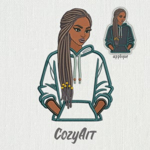 May include: Embroidered design of a person with long brown braids wearing a white hoodie with the text "CozyAit" below. The design is in a teal color and includes yellow beads in the braids.