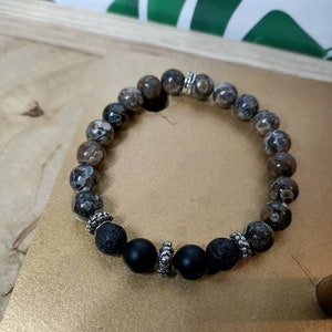 Bracelet for men made of natural stones of turitelle agate, onyx and lava stone with metal beads.
