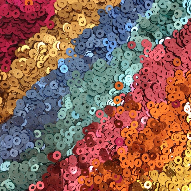 Mixed colour 3mm circle sequins made from 20% recycled plastic.