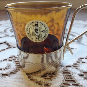 Coffee set, coffee cups, amber glass tumblers with metal stand, sugar bowl, vintage Duralex France tableware, 1970s.