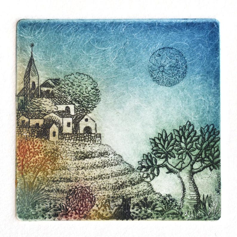 May include: A square art print depicting a village scene under a moonlit sky. The artwork features a church, houses, trees, and a full moon. The color palette includes blues, greens, and earth tones, creating a serene landscape.