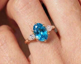 Oval Blue Topaz Engagement Ring, 14K Gold Three Stone Ring with Pear Cut Side Stones, December Birthstone Promise Ring, Statement Ring