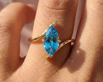 1.5ct Marquise Blue Zircon Ring, December Birthstone Engagement Ring, 14K Gold Curved Bypass Nature Inspired Ring