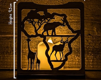 May include: A black metal candle holder shaped like the continent of Africa. The holder features cutouts of animals including a giraffe, an elephant, and an antelope. The candle holder is 8.5 cm wide and 9.5 cm tall.