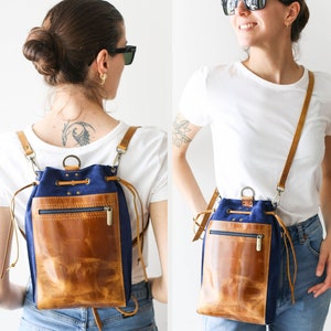 May include: A blue and brown convertible backpack with adjustable straps. The backpack can be worn as a shoulder bag or a crossbody bag. Standard Size. Convertible Style. Strap Width: 1.5CM.
