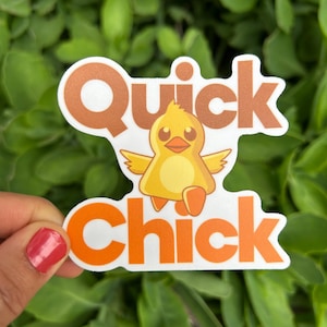 May include: A sticker with the words "Quick Chick" in orange and white. The sticker features a cartoon chick with yellow and orange coloring, wings spread, and a smiling expression. The background is green foliage.