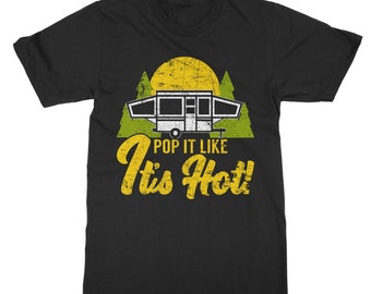 May include: Black t-shirt featuring a yellow graphic of a pop-up camper in front of a sun and trees. The text "Pop it like it's hot!" is written in yellow below the camper.
