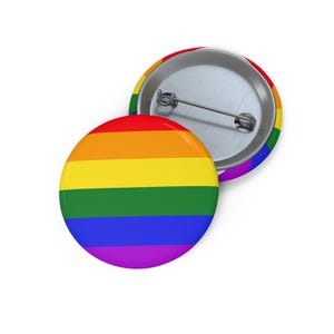 May include: A rainbow pride flag button pin with a silver back and a pin closure.