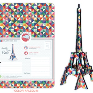 May include: A colorful, geometric Eiffel Tower model made of cardboard. The model is 100 grams and is easy to assemble. The packaging includes a postcard with a space to write a message and the text "La Belle Dame Paris".