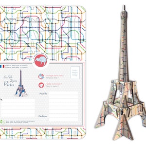 May include: A postcard featuring a colorful illustration of the Eiffel Tower with a Parisian metro map pattern. The postcard has a space for a message and the text "La Belle Dame Paris" on the front.