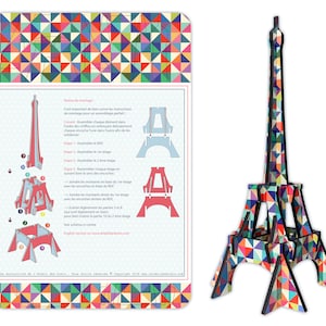 May include: A colorful, geometrically patterned Eiffel Tower model made of wood. The model is assembled in stages, with instructions for each step. The instructions are in French.
