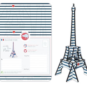 May include: A blue and white striped Eiffel Tower model postcard kit. The postcard features a red heart, the text "La Belle Dame Paris", and a kiwi bird logo. The kit is made of wood from sustainable forests and is easy to assemble.