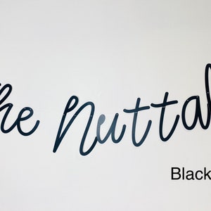 May include: Black script lettering on a white wall reads "The Nuttalls" with the text "Black Pearl" below.