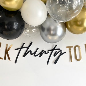 May include: Gold, black, and silver balloons with confetti. A banner reads "TALK thirty TO ME" in gold and black letters.