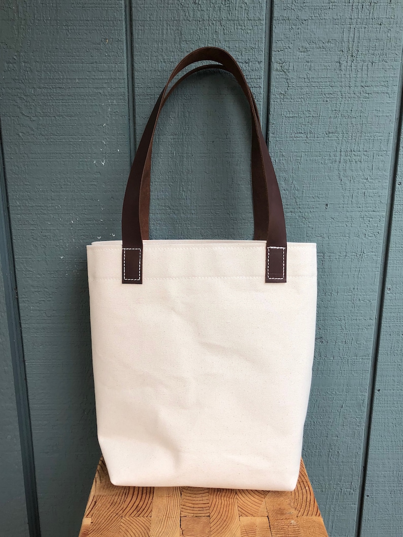 Natural canvas tote with dark brown leather straps