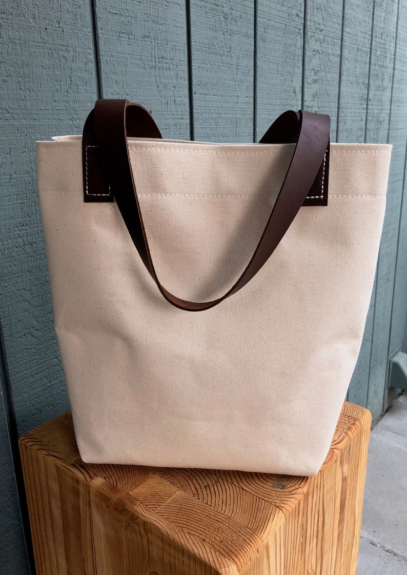Natural canvas tote with dark brown leather straps