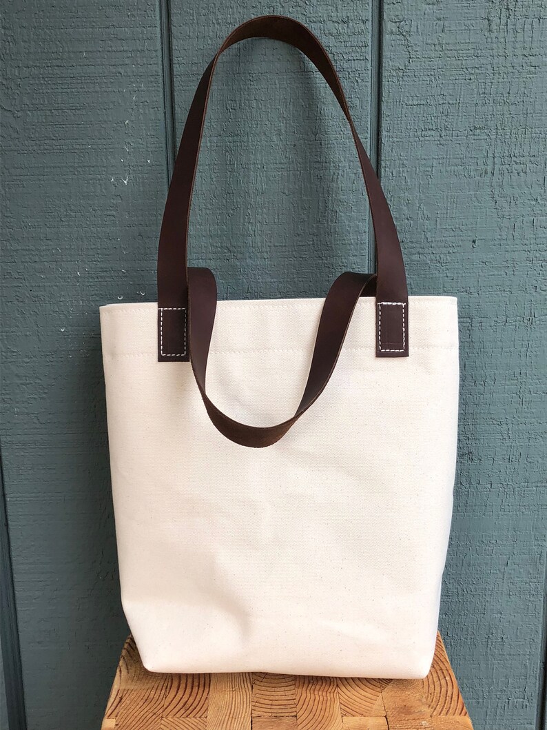 Natural canvas tote with dark brown leather straps
