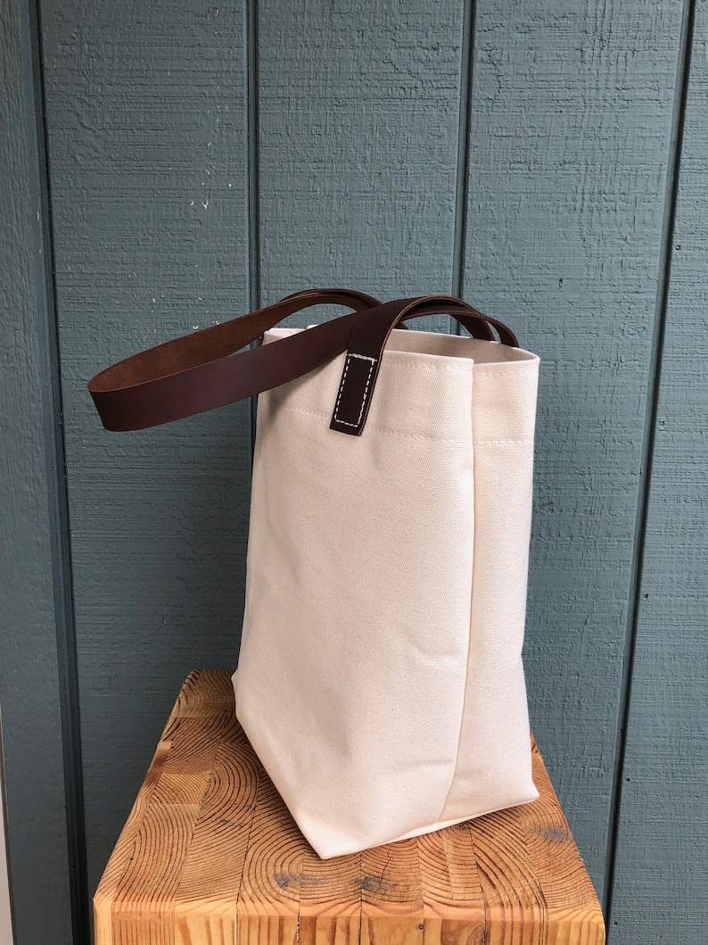 Natural canvas tote with dark brown leather straps