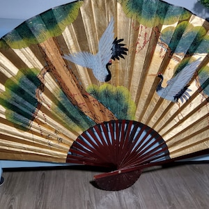 Chinese large fan featuring Painting of Cranes and Lotus Plants with bamboo spokes.