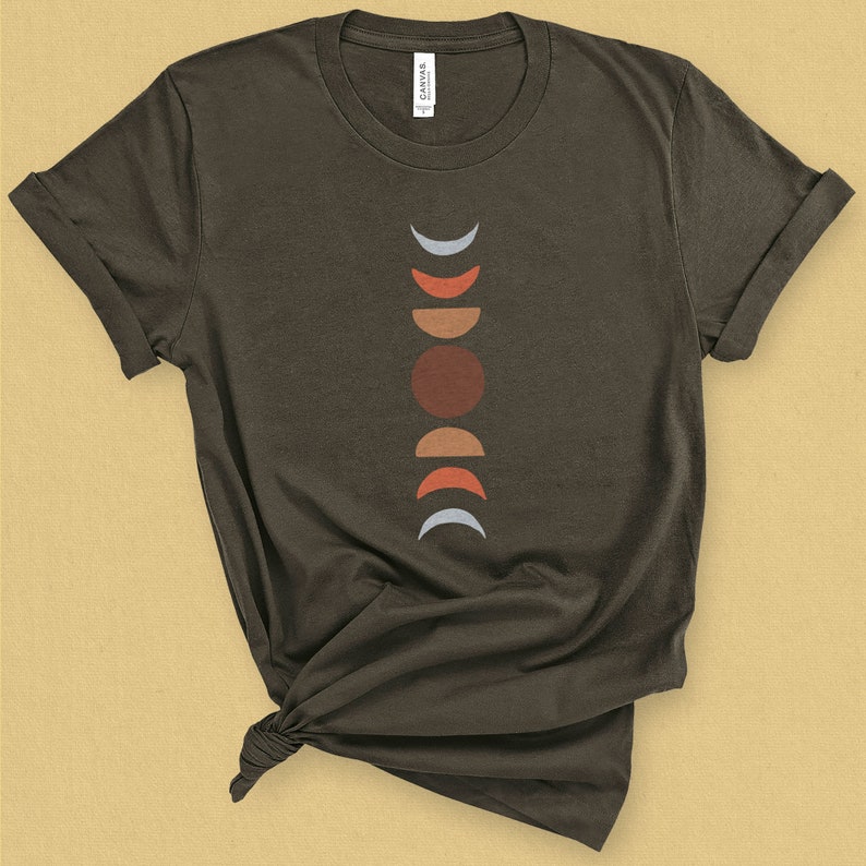 May include: A dark brown t-shirt with a graphic design of a moon phases pattern in shades of blue, red, and orange.