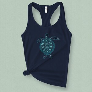 May include: A navy blue tank top with a teal blue graphic of a stylized sea turtle.