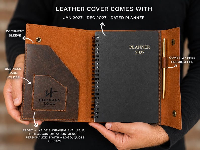 May include: A brown leather planner cover featuring a document sleeve, a business card holder with a company logo, and a spiral-bound black planner dated Jan 2027 - Dec 2027. A gold-colored pen is held in a side loop, and the cover has snap closures.