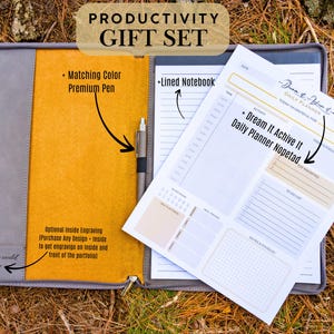 May include: A gray leather portfolio with a yellow interior, a lined notebook, a pen, and a daily planner with the text "Dream It Achieve It Daily Planner Notepad".