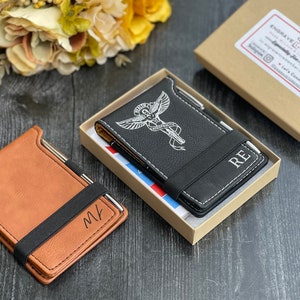 Puede incluir: Dos cubiertas de cuaderno de cuero personalizadas con un portaplumas. Una cubierta es marr&oacute;n con las iniciales "MK" y la otra es negra con un s&iacute;mbolo m&eacute;dico y las iniciales "RE".