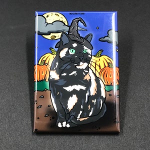 May include: Rectangular magnet featuring a black, white, and orange cat wearing a witch hat, set against a Halloween night scene. The background includes pumpkins, a full moon, and clouds. The text "THE ILLUST LUKOI" is visible.
