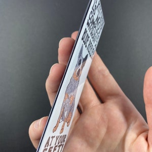 May include: A white rectangular magnet with a cartoon blue heeler dog and the text "Life is not complete without a blue heeler at your feet".