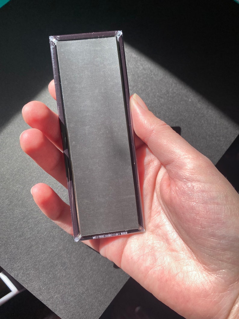 May include: A rectangular magnet with a black background and white text that reads "MADE IN THE USA" on the back.