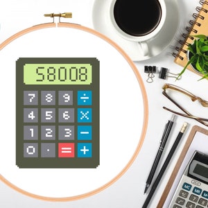 May include: A brown calculator with a green display showing the number 58008. The calculator has a black and white keypad with the numbers 7, 8, 9, 4, 5, 6, 1, 2, 3, 0, and a decimal point. The calculator also has buttons for addition, subtraction, multiplication, division, and equals.