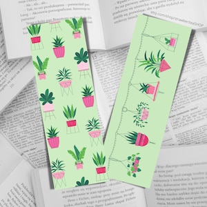 May include: A set of two green and pink bookmark designs featuring a repeating pattern of potted plants. The first bookmark features plants in hanging pots, while the second bookmark features plants in pots on stands. Both bookmarks have a light green background.