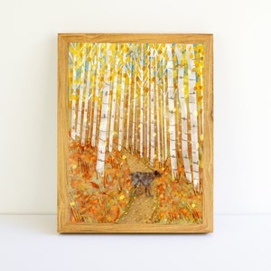 May include: A framed watercolor painting of a dog walking through a forest of birch trees with yellow leaves on the ground.