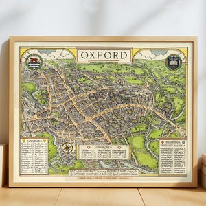 May include: A framed vintage map of Oxford, England, with detailed illustrations of colleges, churches, and buildings. The map features a light brown wooden frame and is printed with a variety of colors, including green, yellow, and brown. The word "OXFORD" is displayed at the top.