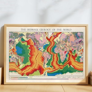 May include: A framed map titled "THE BEDROCK GEOLOGY OF THE WORLD." The map features a colorful geological representation of the world, with various regions depicted in shades of green, red, orange, blue, and pink. The map is encased in a light brown wooden frame.