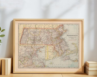 May include: Framed vintage map of Massachusetts, featuring detailed road and city markings. The map is in a light wood frame, with the state name prominently displayed. The map's colors include beige, red, and green.