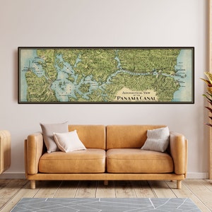 May include: A framed vintage map of the Panama Canal, showing an aeronautical view. The map is mainly green and blue, with the text "Aeronautical View of the Panama Canal". The frame is black.