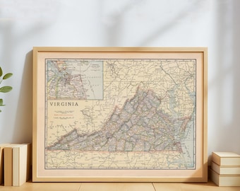 May include: Framed vintage map of Virginia, featuring detailed roads, cities, and geographical features. The map is in a light wood frame, with the word "VIRGINIA" prominently displayed. The map has a beige and brown color scheme.