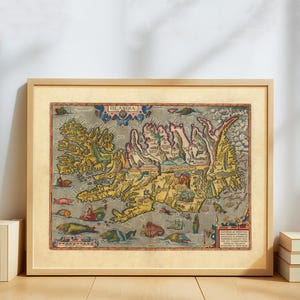 May include: Framed vintage map of Iceland, titled "Islandia." The map features detailed illustrations of the island's geography, with sea creatures and decorative elements. The map is in a wooden frame.