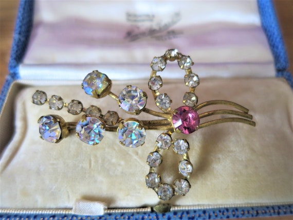 A vintage diamond and ruby paste gold tone brooch - image 1