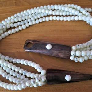 A vintage five strand necklace with attractive wooden hook fastening in the style of Gerda Lyngaard