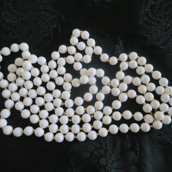 A lovely long flapper length milk glass bead necklace