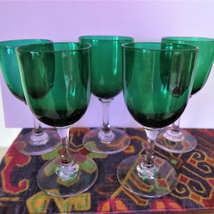 A set of five antique green wine glasses