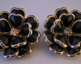 An elegant pair of vintage gold tone and black Lucite CIRO flower head clip on earrings