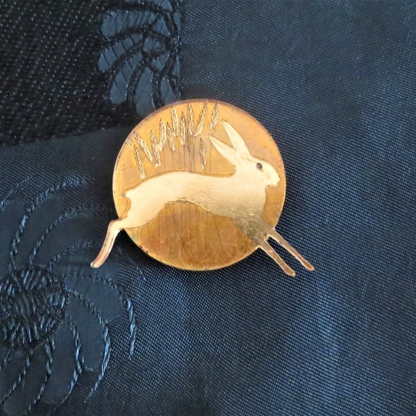 An unusual vintage modernist "Hare" design circular gilt perspex brooch