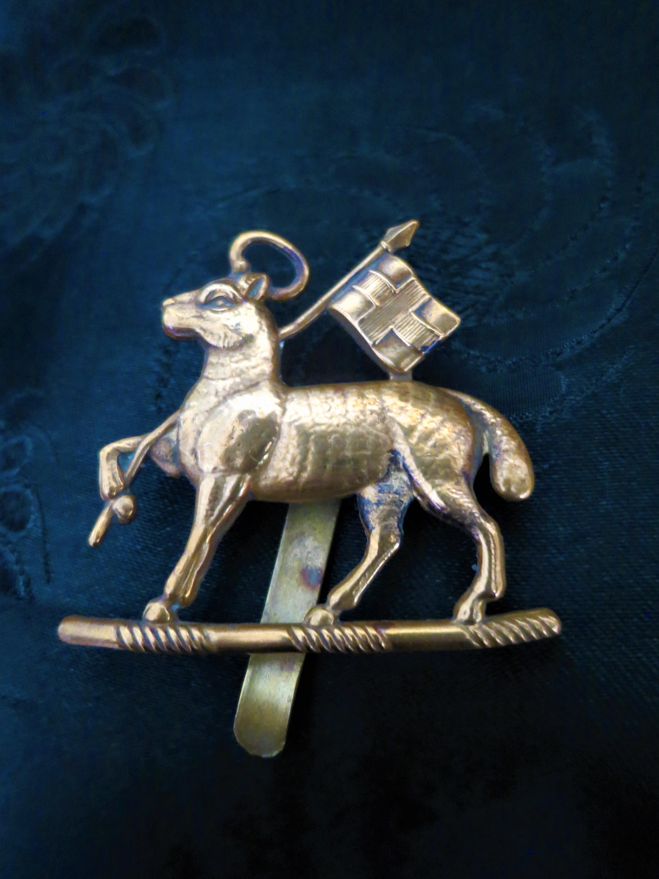 An early antique/vintage Paschal Lamb cap badge from the Queens Royal West Surrey Regiment