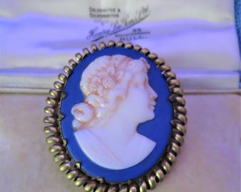 A striking antique blue ceramic cameo in a gold metal frame