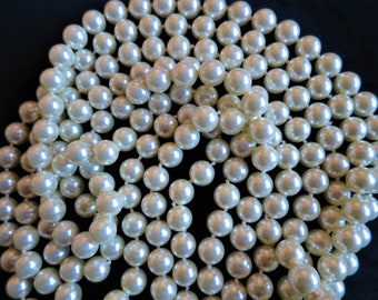 A stunning set of two vintage long faux pearl flapper length necklaces